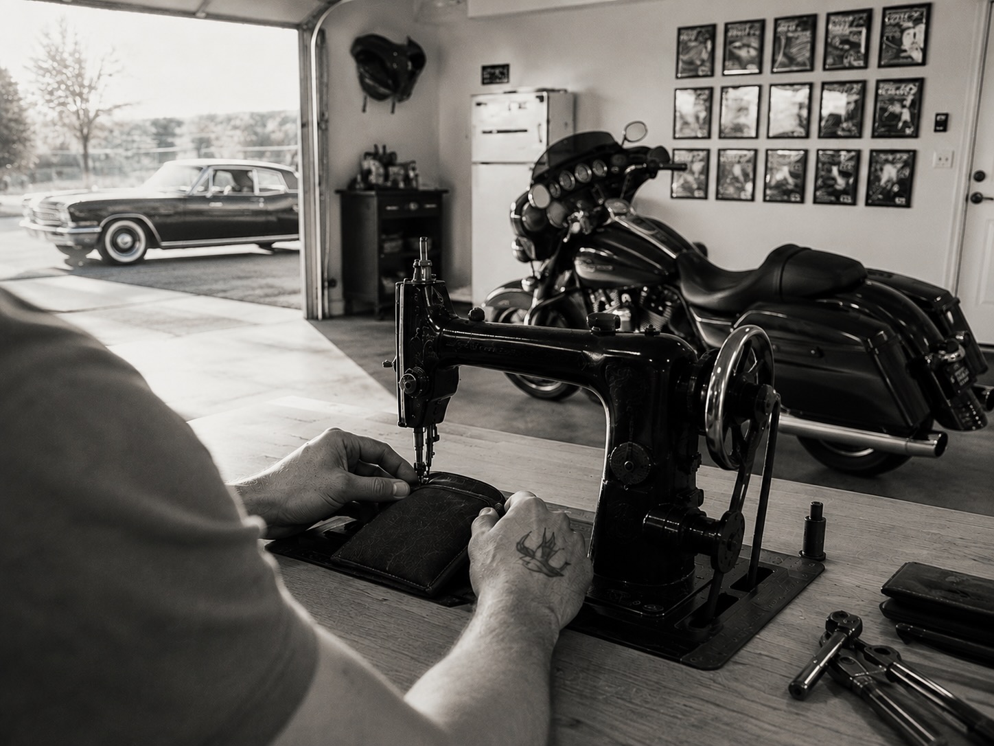 A Sparrow Bag being sewn on a vintage machine in a motorcycle garage